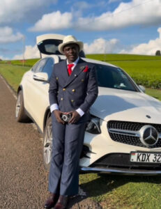 Onyango Tate standing next to his Mercedes-Benz