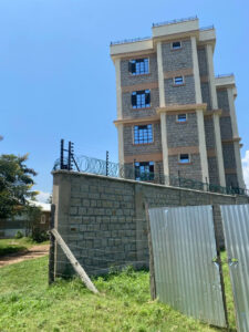 The wall of the apartment showing how it is sorrounded with elctric fence